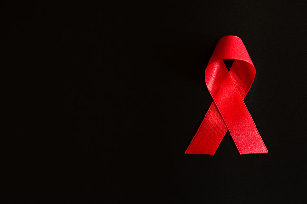 consciencia-de-fita-vermelha-closeup-em-fundo-preto-para-a-campanha-do-dia-mundial-da-aids_53476-2864